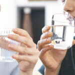friends drinking a fresh glass of water at home